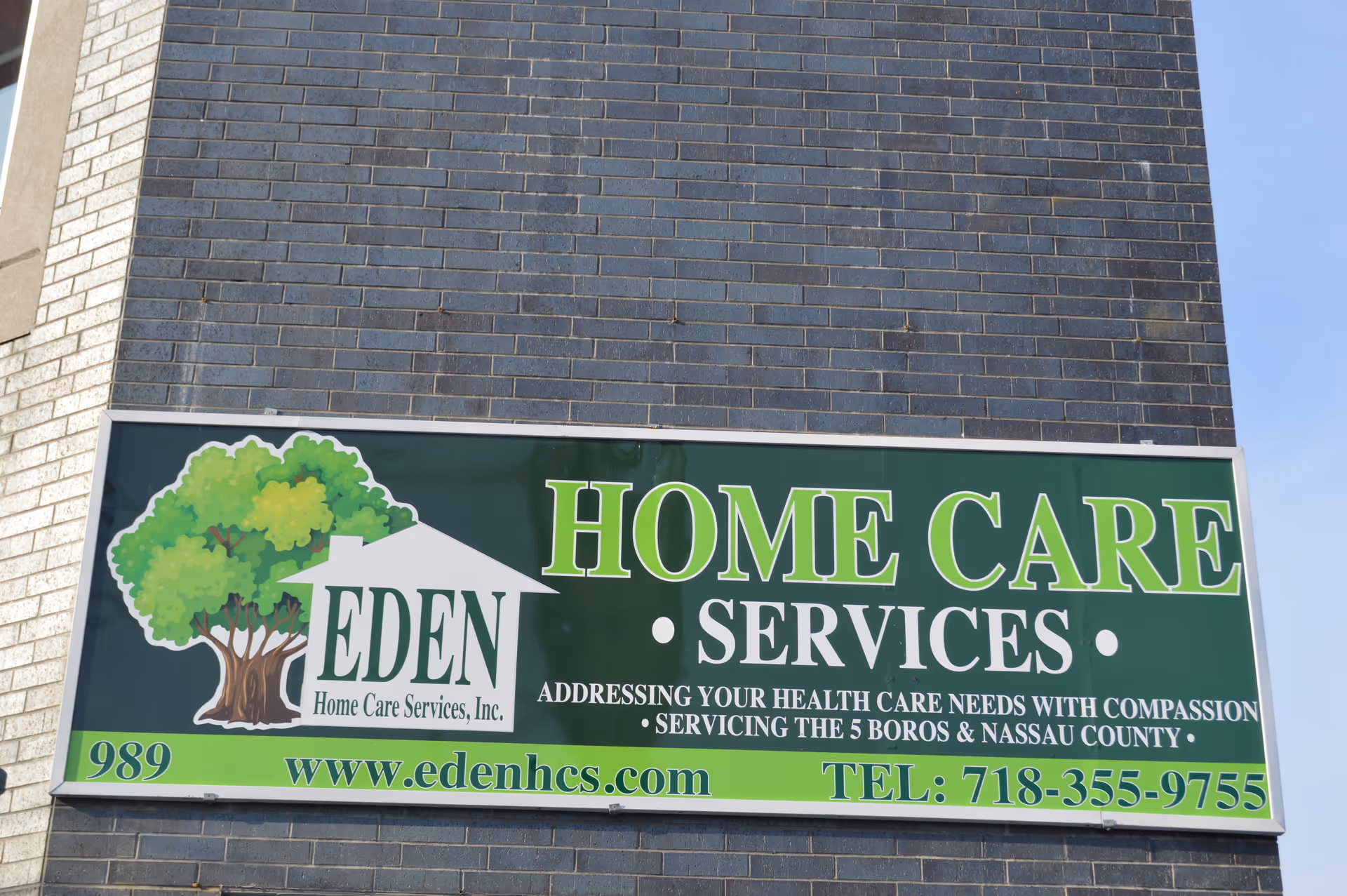 A large exterior sign on a brick building advertising Eden Home Care Services.