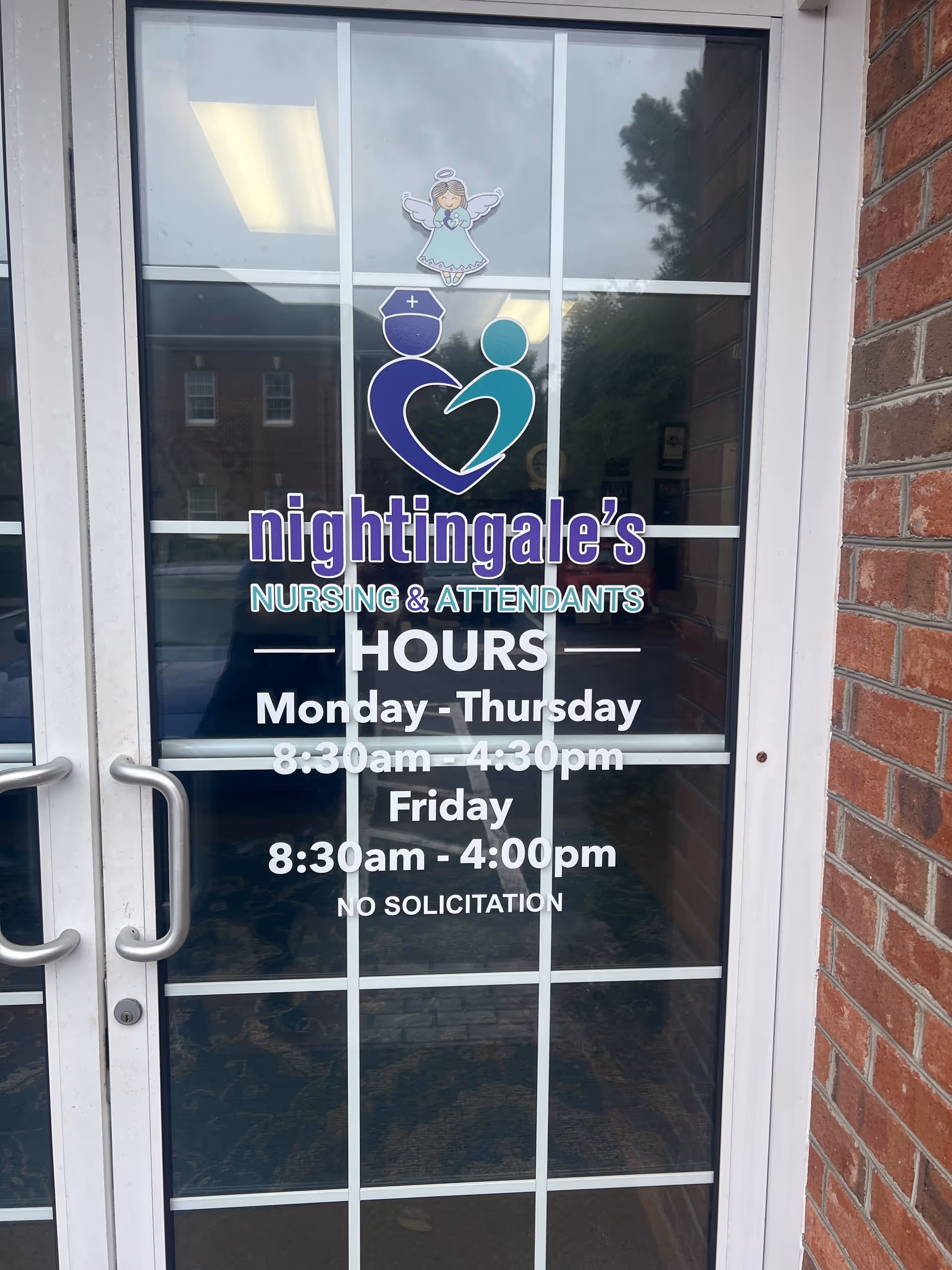 Glass door entrance with Nightingale's Nursing and Attendants logo and hours signage.