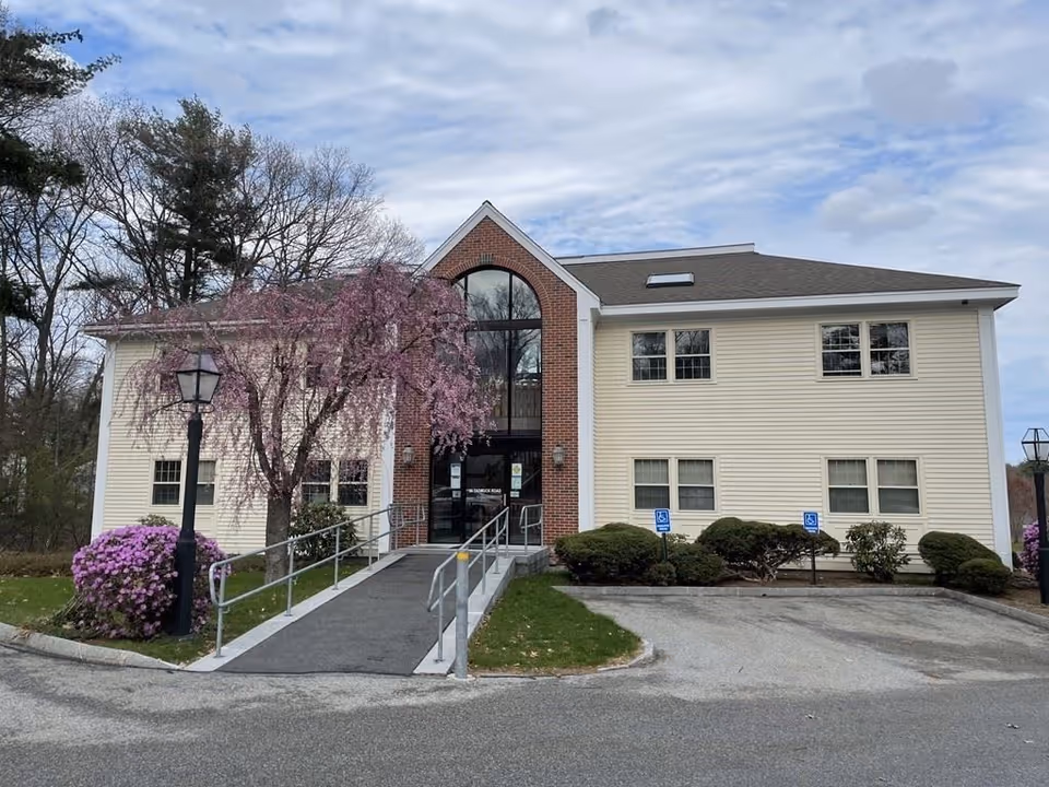 Front view of Granite Willow Home Care facility with ramp and flowering tree.