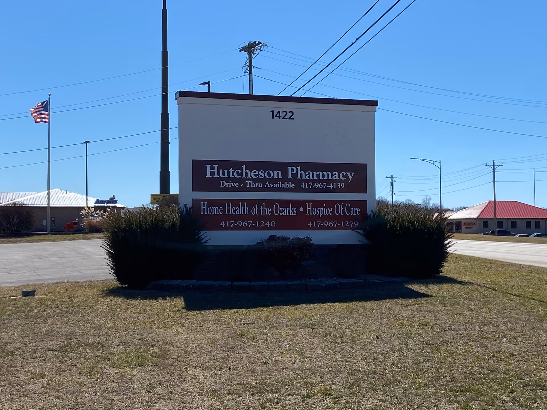 Exterior sign in front of a building advertising Hutcheson Pharmacy and Home Health of the Ozarks.