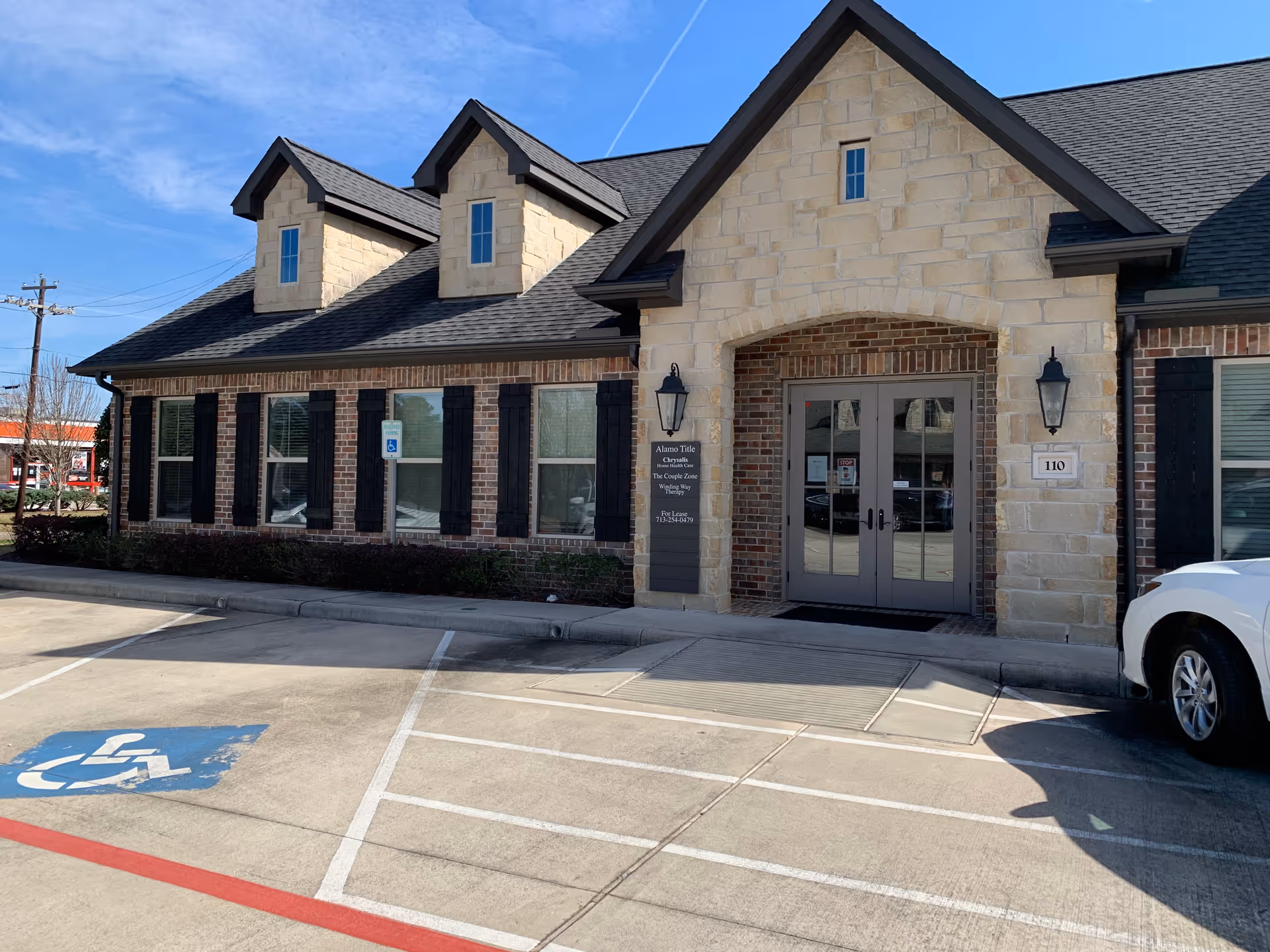 Exterior view of Therapy Partners of Texas LLC facility entrance with handicap parking.