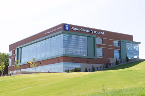 Exterior view of Akron Children's Hospital building on a grassy hill