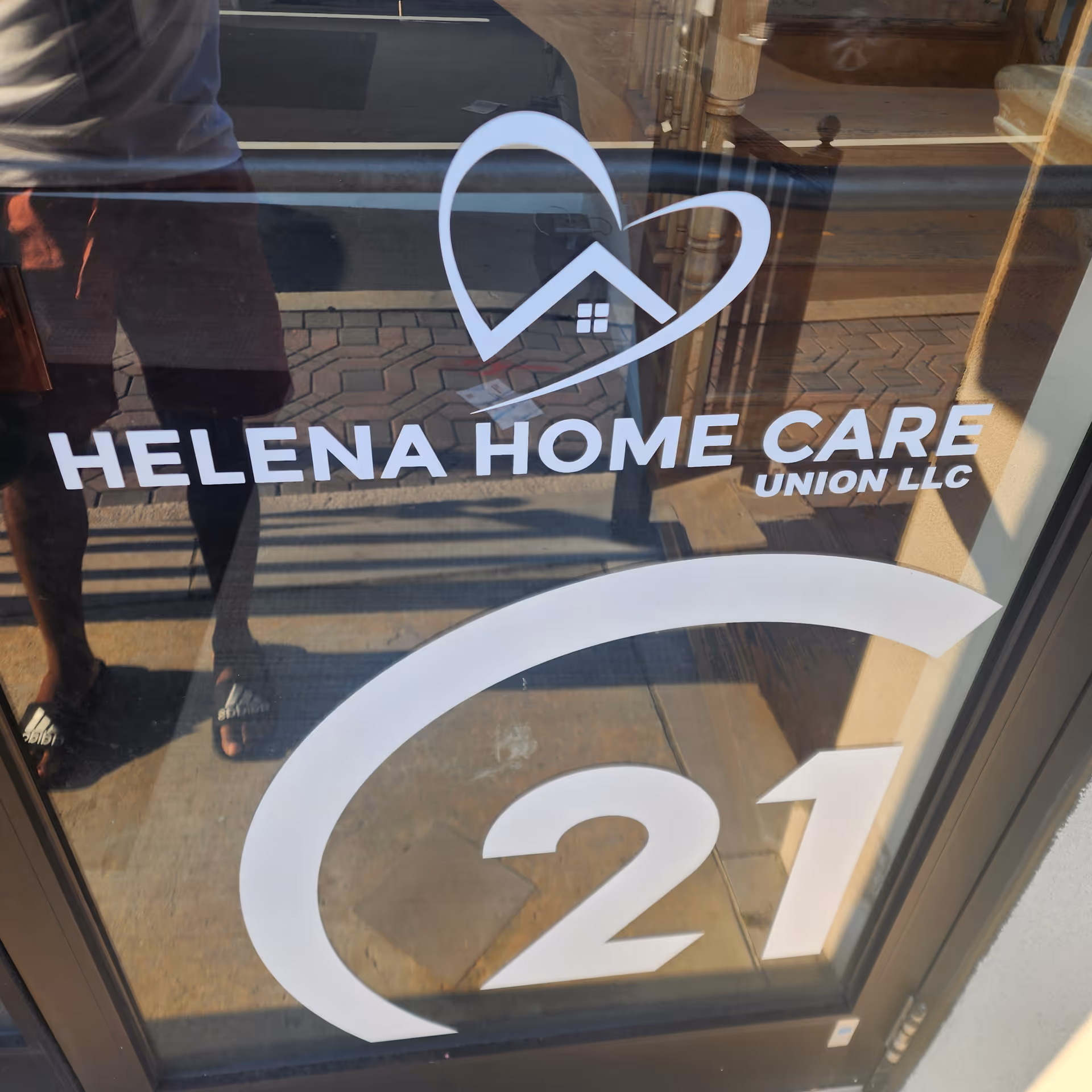 Glass entrance door displaying Helena Home Care Union LLC logo and a large 21
