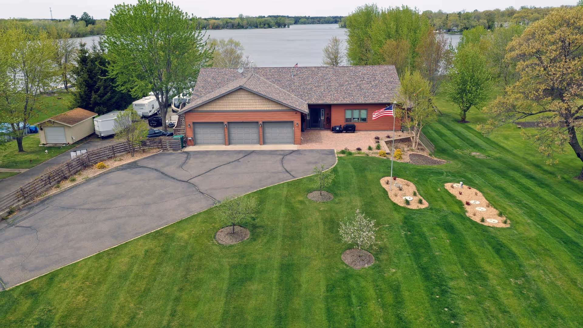 Aerial view of Norden SLS facility front with driveway, flagpole, and manicured lawn.