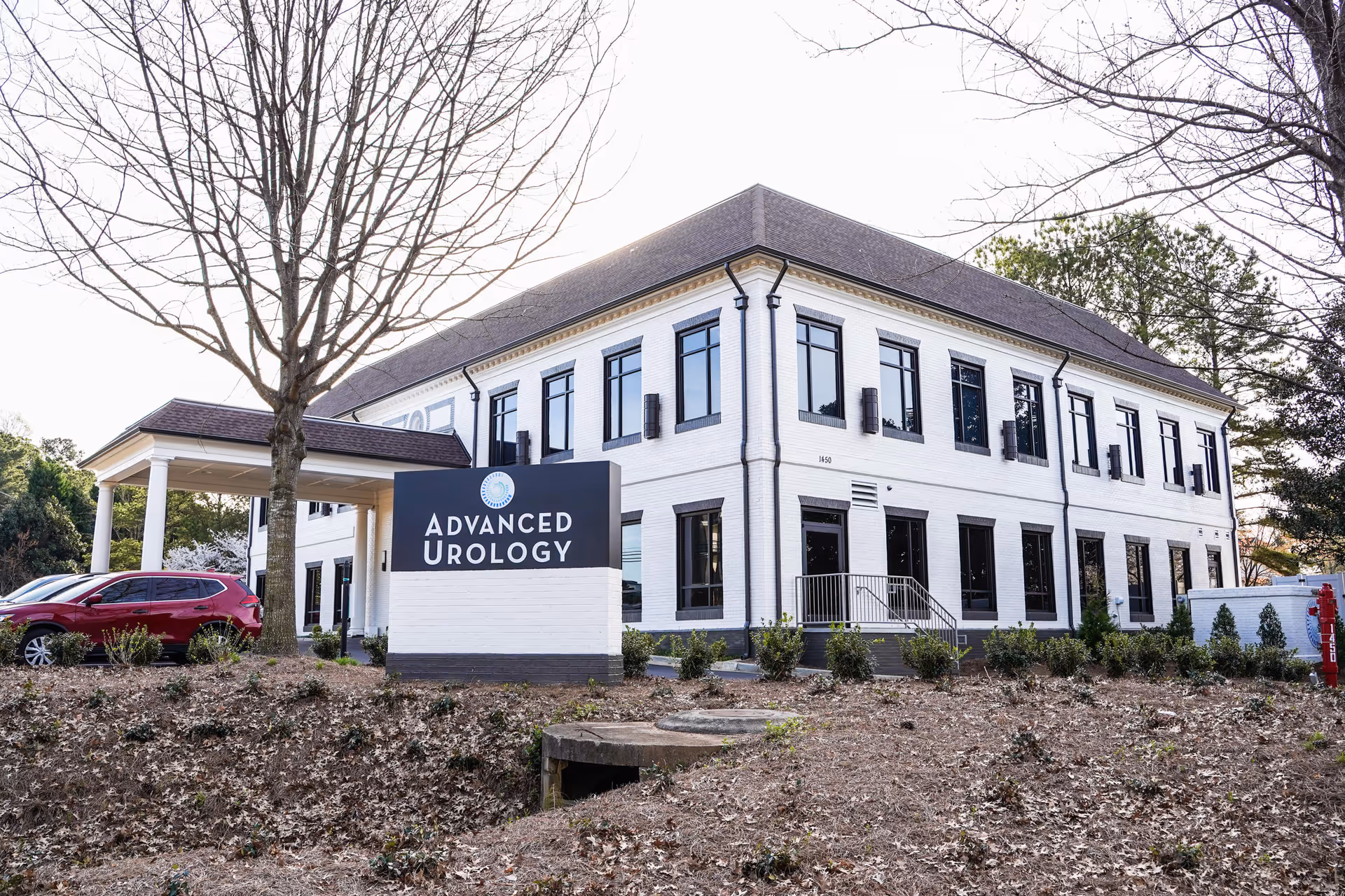 A white two-story medical building with a large Advanced Urology sign.