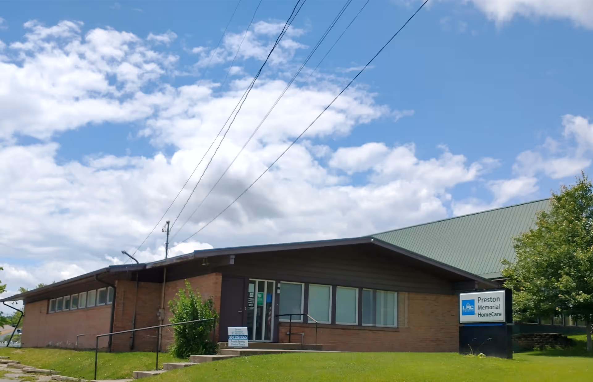 Front view of a single-story brick building with Preston Memorial HomeCare sign.