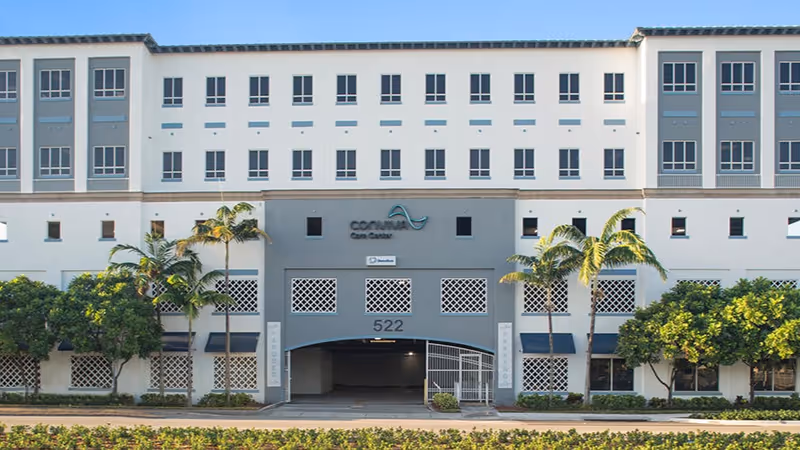 Exterior view of Fidel Cintas, MD facility front with palm trees
